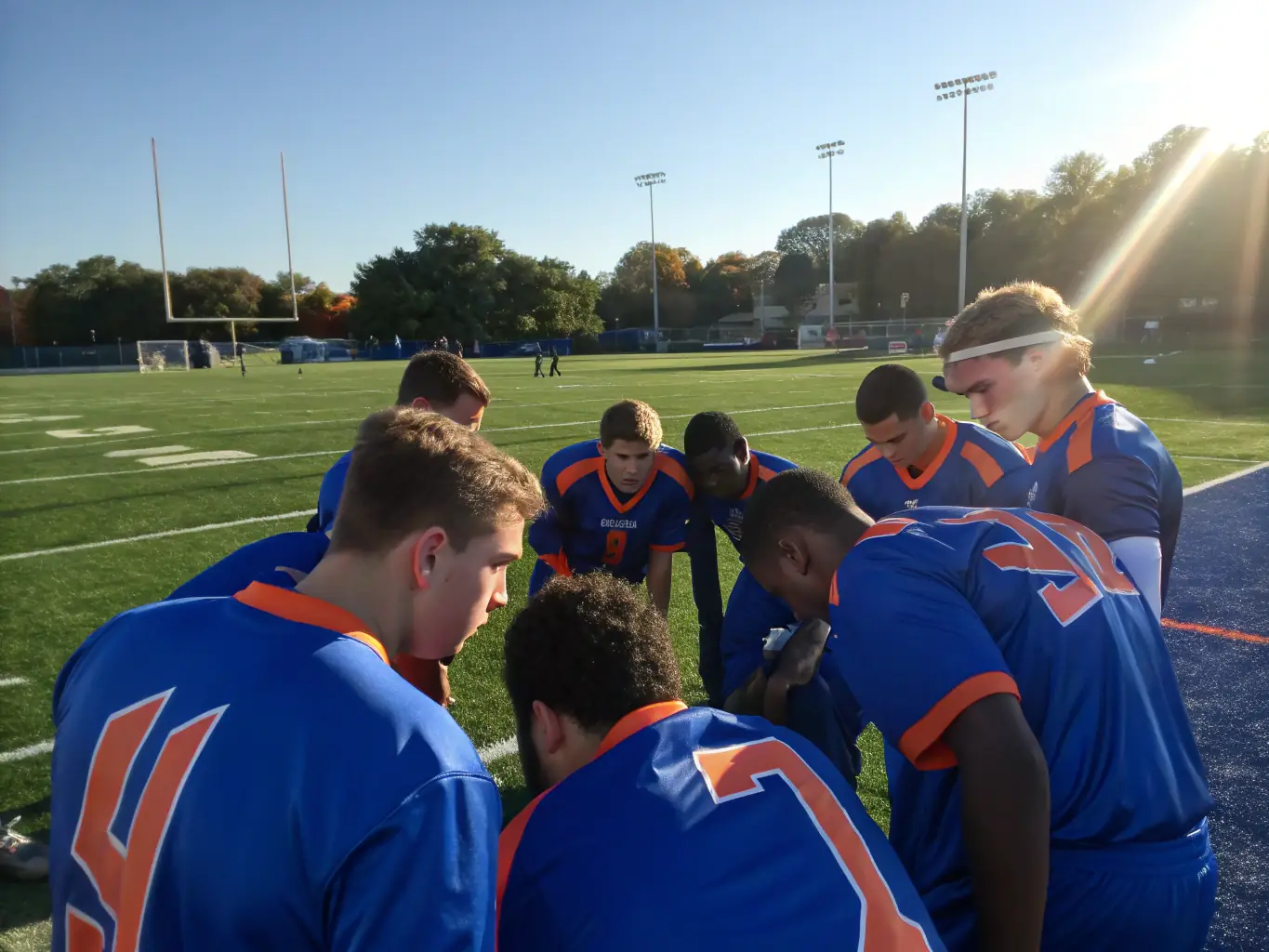 A group of diverse team members strategizing during a football match, emphasizing collaboration and effective communication.